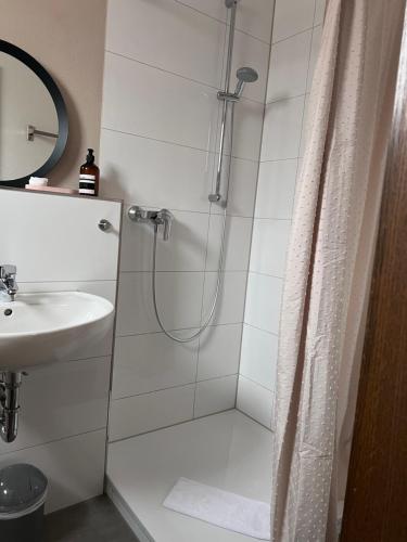 a bathroom with a shower and a sink at Pension Krone Sternenfels in Sternenfels