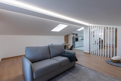 a living room with a couch and a staircase at Direita House 131 in Braga