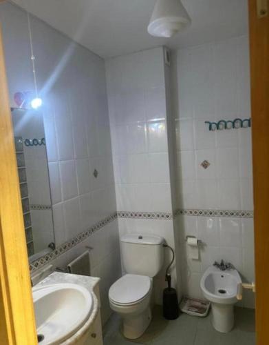 a small bathroom with a toilet and a sink at Alojamiento K&K Habitacion encasa particular in Valencia