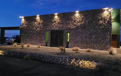 a building with lights on the side of it at Casona Islas Blancas in Camarones
