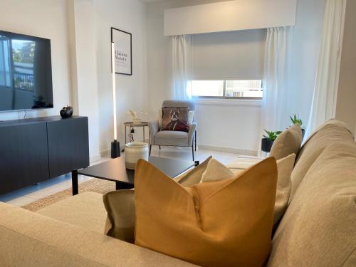 a living room with a couch and a table at Central Boutique Twenty One in Nicosia