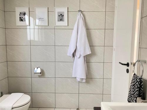 a bathroom with a white towel hanging on a wall at Central Boutique Twenty One in Nicosia