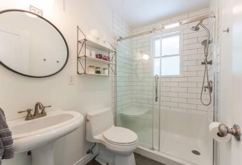 a bathroom with a toilet and a sink and a shower at Waterfront Haliburton, All Season, Fully Equipped Cottage! in Haliburton