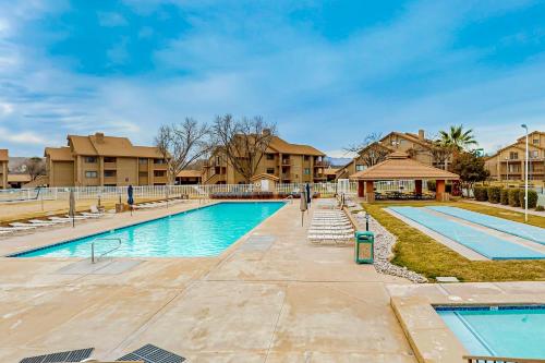 a swimming pool with blue water in a resort at Mountain Views at the Village in St. George