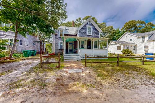 a house with a fence in front of it at Gingerbread Dream in Oak Bluffs