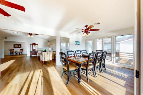 a dining room and living room with a table and chairs at What a View in Bella Vista