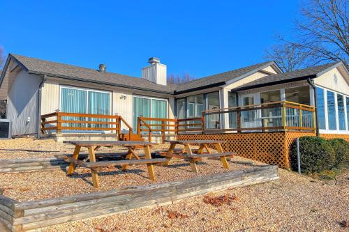 a house with two picnic tables in front of it at What a View in Bella Vista