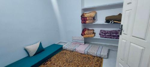 a room with a room with pillows and a door at النضافة الهدوُ والأمان in Taghit