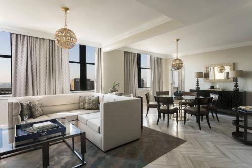 a living room with a couch and a dining room at The Ritz-Carlton, Philadelphia in Philadelphia