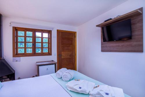 Una cama o camas en una habitación de Pousada das Videiras