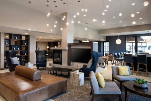 a living room with a couch and chairs and a television at Residence Inn by Marriott Boulder Canyon Boulevard in Boulder