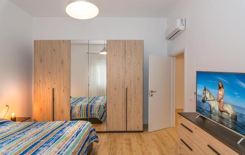 a bedroom with two beds and a flat screen tv at Casa vacanze da Antonio ristrutturata LUGLIO 2023 in Viareggio