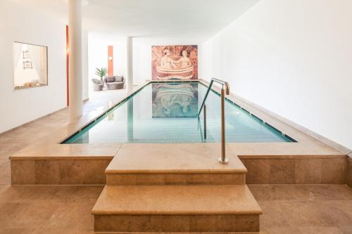 a swimming pool in the middle of a house at Romantik Hotel Jagdhof in Caldaro
