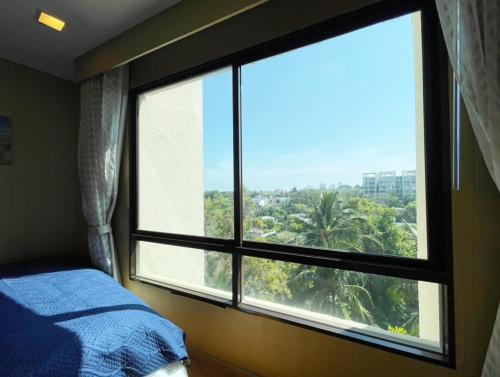 a bedroom with a large window with a view at Marrakesh Hua Hin condo 2 bedrooms with stunning sea view and pool view in Hua Hin