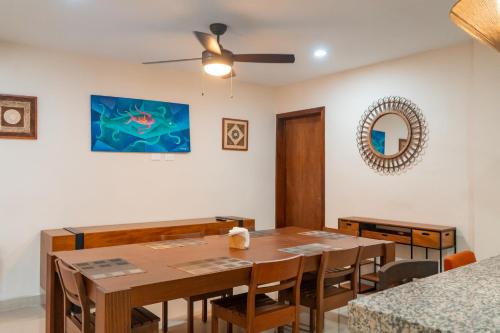 a dining room with a table and a ceiling fan at Departamentos Sol, Mar y Arena in Isla Mujeres