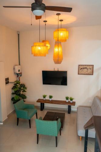 a living room with a table and chairs and lights at Departamentos Sol, Mar y Arena in Isla Mujeres