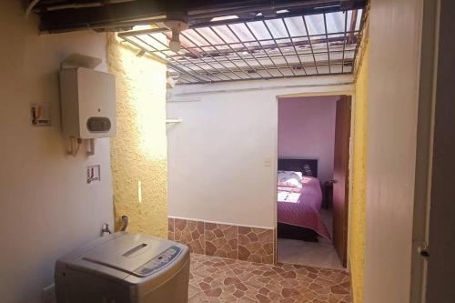 a room with a bathroom with a bed and a toilet at Apartamento Amoblado en Laureles in Medellín