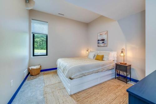 a white bedroom with a bed and a window at Blue Haven in South Haven