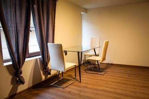 a dining room with a table and two chairs at R34 Boutique Guest House in Veliko Tŭrnovo