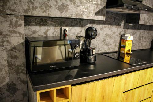 a microwave sitting on top of a kitchen counter at R34 Boutique Guest House in Veliko Tŭrnovo
