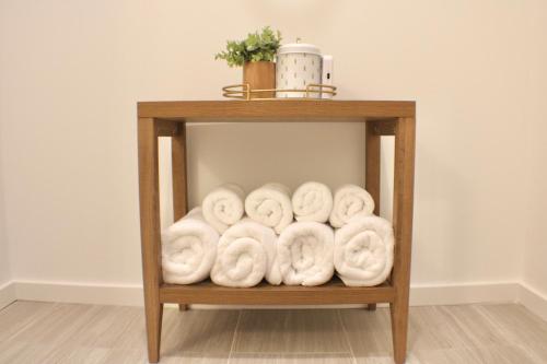 a pile of towels on a shelf in a room at Centrally located modern townhome free parking in Chattanooga