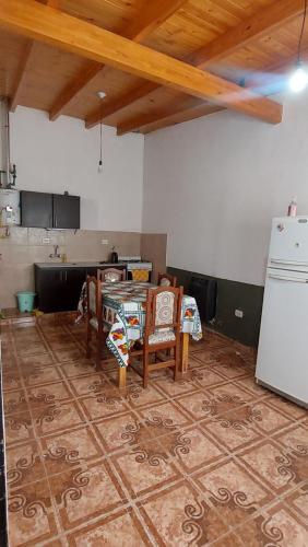 a kitchen with a table and chairs and a refrigerator at MALARGÜE in Malargüe