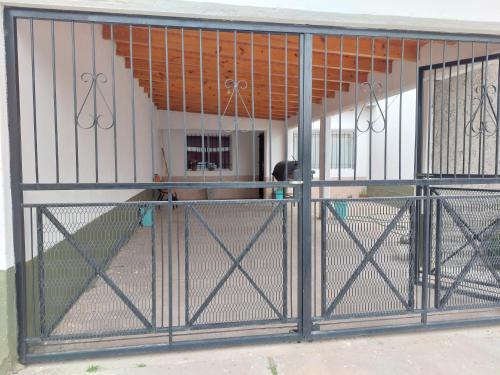 an open gate in front of a house at MALARGÜE in Malargüe