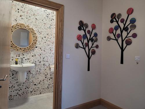 a bathroom with a sink and a mirror at Maisie and Bea's cottage in Galway