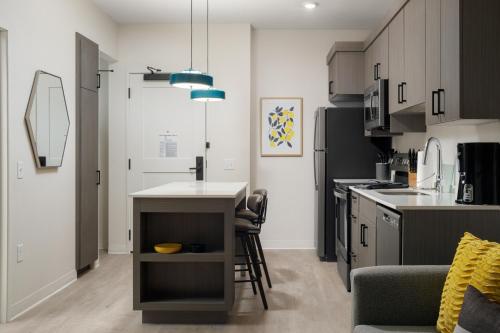 a kitchen with a small island in the middle at WaterWalk Extended Stay by Wyndham Huntsville in Huntsville