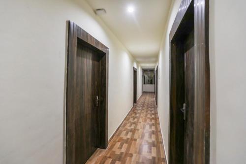 a hallway with two doors and a wooden floor at OXY Royal Residency in Rānchī
