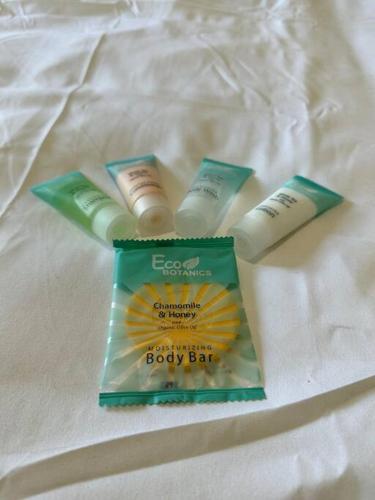 a group of three products sitting on a bed at Newly Updated Cozy Home in Garland