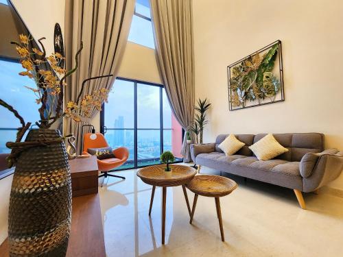 a living room with a couch and a table at Loft Suite CityView near JB CIQ 7Pax in Johor Bahru