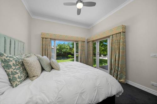 a bedroom with a white bed with a window at Stay at beautiful Rea in Shepparton