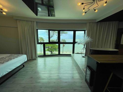 a bedroom with a bed and a large window at Villa Marbella by Potenza Rentals in Santo Domingo