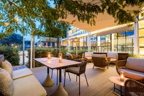 a patio with a table and chairs and a building at Radisson Blu Hotel, Hamburg in Hamburg