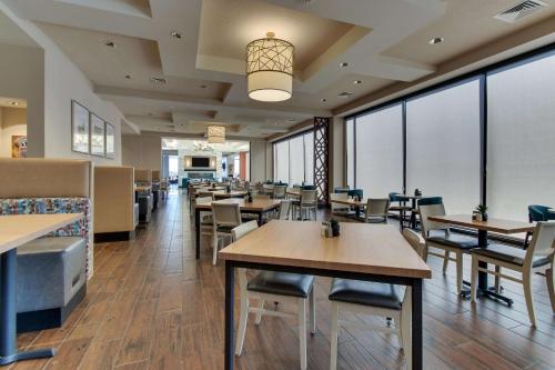 a restaurant with tables and chairs and windows at Drury Plaza Hotel Nashville Downtown in Nashville