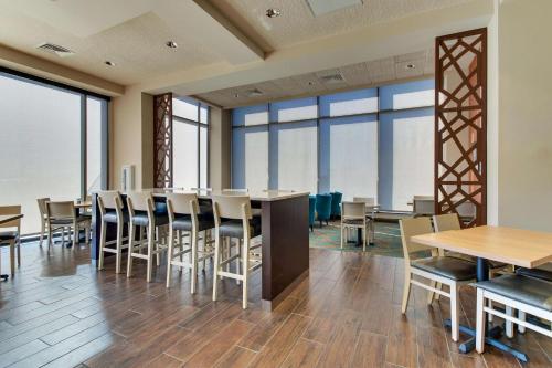 a dining room with tables and chairs and windows at Drury Plaza Hotel Nashville Downtown in Nashville