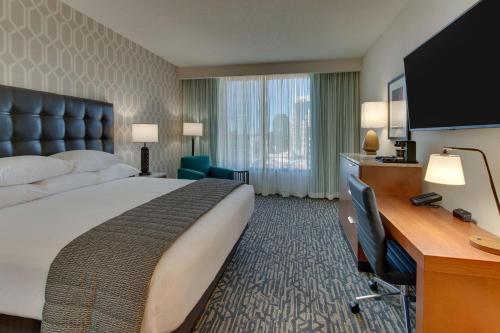 a large hotel room with a large bed and a desk at Drury Plaza Hotel Nashville Downtown in Nashville