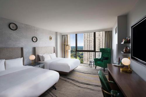 a hotel room with two beds and a large window at The Starling Atlanta Midtown, Curio Collection by Hilton in Atlanta