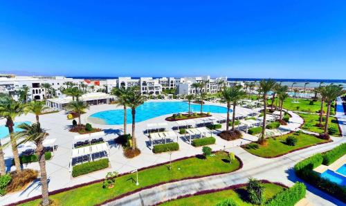 an aerial view of a resort with a pool and palm trees at Steigenberger Alcazar in Sharm El Sheikh