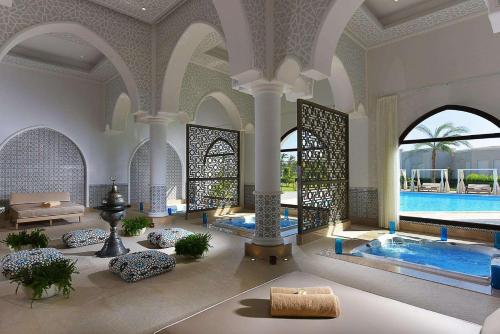 a large room with a swimming pool in a building at Steigenberger Alcazar in Sharm El Sheikh