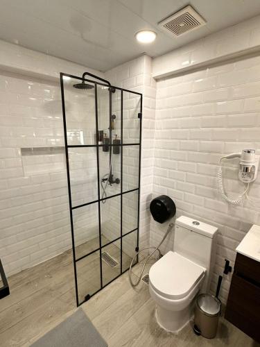 a bathroom with a toilet and a glass shower at Villa Marbella by Potenza Rentals in Santo Domingo