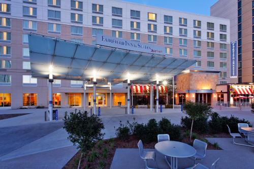 a hotel with tables and chairs in front of a building at Fairfield Inn Suites Indianapolis Downtown in Indianapolis