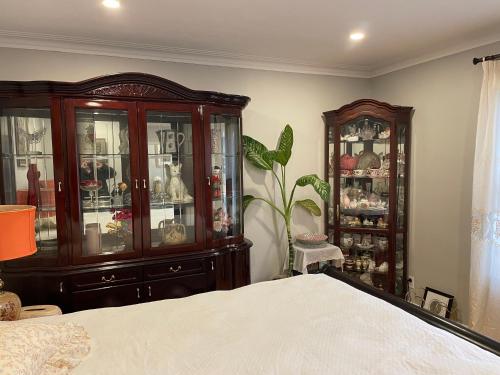 a bedroom with a china cabinet and a bed at Bright room in a castle in Markham