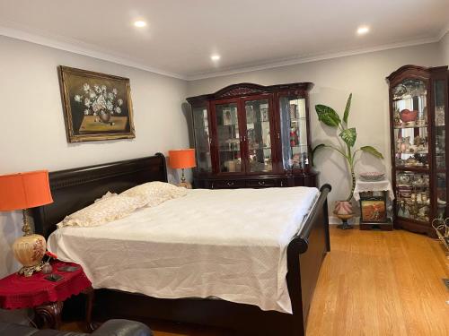 a bedroom with a bed and a dresser at Bright room in a castle in Markham