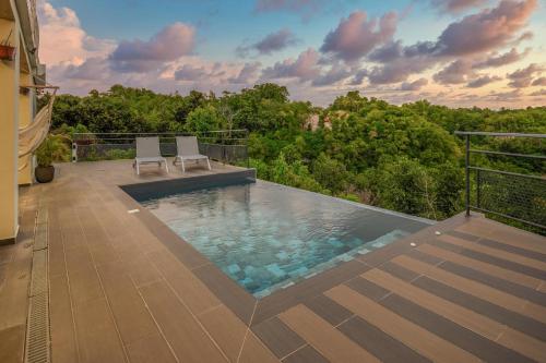 a swimming pool on the balcony of a house at Villa Galba in Le Gosier