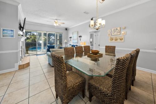a dining room and living room with a glass table and chairs at Sea-renity Home in Sunnyside