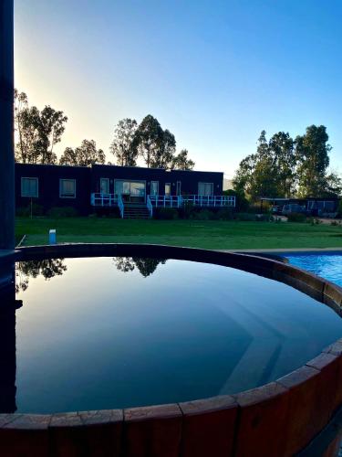 a pool of water with a building in the background at Casa Costa Zapallar in Catapilco