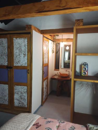 a bedroom with a bed and a desk and a mirror at Cabaña Zeus en Villas de San Felipe in Oicatá