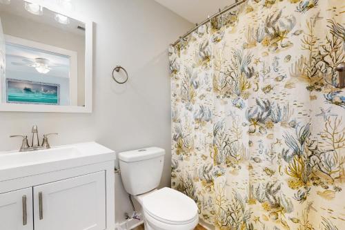 a bathroom with a toilet and a shower curtain at Scallop in Buxton